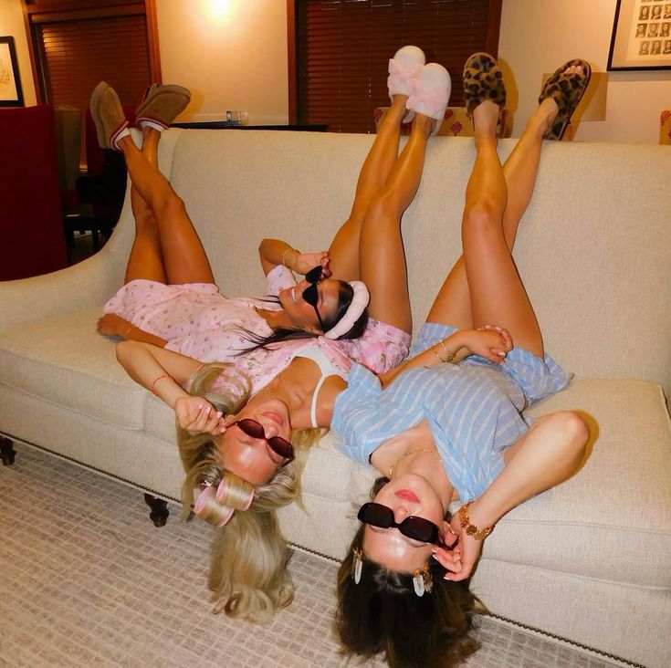 Three friends lounging upside down on the couch